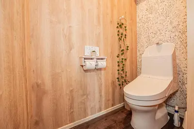 a bathroom with a toilet and a wooden wall at 301 6 mins walk from Higashi-Jujo Station Comfortable 1 bedroom apartment on the 3rd floor Direct access to Akihabara and Ueno in Tokyo