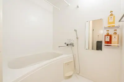a white bathroom with a shower and a mirror at 301 6 mins walk from Higashi-Jujo Station Comfortable 1 bedroom apartment on the 3rd floor Direct access to Akihabara and Ueno in Tokyo