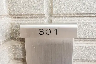 a sign with the number on a wall at 301 6 mins walk from Higashi-Jujo Station Comfortable 1 bedroom apartment on the 3rd floor Direct access to Akihabara and Ueno in Tokyo