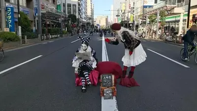 a painting of two people in the middle of the street at \u677e\u5c4b\u30db\u30c6\u30eb5\u968e in Tokyo