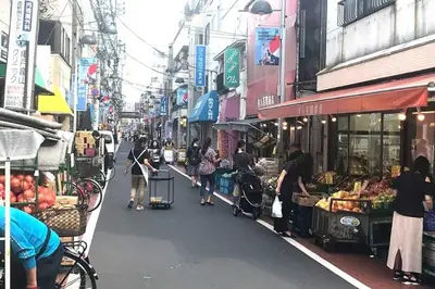 a group of people walking down a street in a market at \u677e\u5c4b\u30db\u30c6\u30eb5\u968e in Tokyo