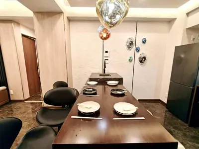 a dining room with a large wooden table and chairs at A1 Shinjuku JR St 8 mins 4 bedrooms and 1 living room 2bathrooms 2toilets Max 12P Direct to Shinjuku Ueno Ginza Shibuya Ikebukuro Yoyogi Shinagawa \u65b0\u5bbf\u533a \u9ad8\u7530\u9a6c\u573a\u8f66\u7ad98\u5206\u949f 4\u5ba41\u53852\u6d74\u5ba42\u536b\u751f\u95f4 \u6700\u592712\u4eba in Tokyo