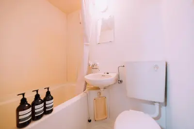 a small bathroom with a sink and a toilet at Showa Bloom Near Shinjuku Station in Tokyo