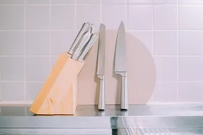 three knives and a knife block on a counter at Showa Bloom Near Shinjuku Station in Tokyo