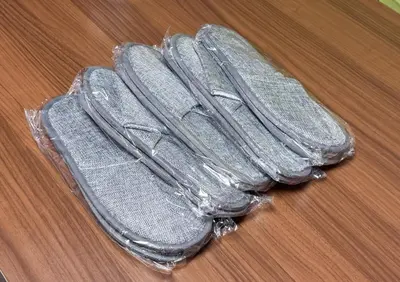 two pairs of flip flops sitting on a table at Shinkoiwa HOUSE in Tokyo