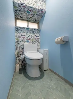 a bathroom with a toilet in a room with blue walls at Shinkoiwa HOUSE in Tokyo
