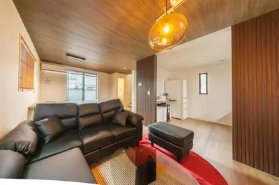 a living room with a leather couch and a red rug at 7min Walk from Station 100sqm Max 10 Direct to Skytree Haneda Narita New Built in Tokyo