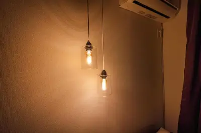two lights hanging from a wall in a room at 7min Walk from Station 100sqm Max 10 Direct to Skytree Haneda Narita New Built in Tokyo