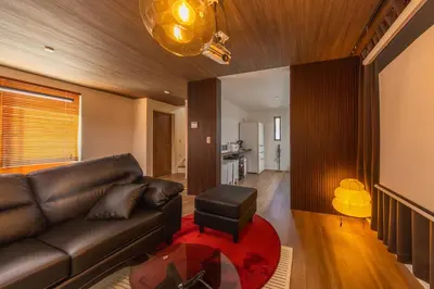 a living room with a leather couch and a table at 7min Walk from Station 100sqm Max 10 Direct to Skytree Haneda Narita New Built in Tokyo