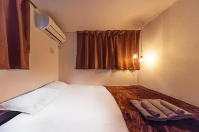 a bedroom with a large bed in a small room at 7min Walk from Station 100sqm Max 10 Direct to Skytree Haneda Narita New Built in Tokyo