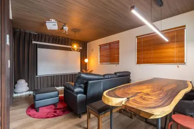 a dining room with a wooden table and leather chairs at 7min Walk from Station 100sqm Max 10 Direct to Skytree Haneda Narita New Built in Tokyo
