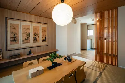 a living room with a table and a chandelier at Shinjuku Zen House 2F 70sqm Traditional Reno Premium Bed R2 in Tokyo