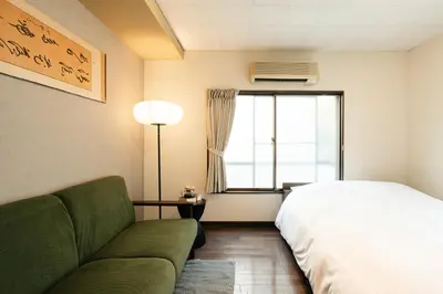 a bedroom with a bed and a couch and a window at Shinjuku Zen House 2F 70sqm Traditional Reno Premium Bed R2 in Tokyo