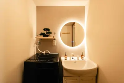 a bathroom with a sink and a mirror at Shinjuku Zen House 2F 70sqm Traditional Reno Premium Bed R2 in Tokyo