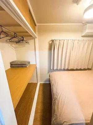 a small bedroom with a bed and a window at Family Friendly Japanese Style Room near Skytree in Tokyo