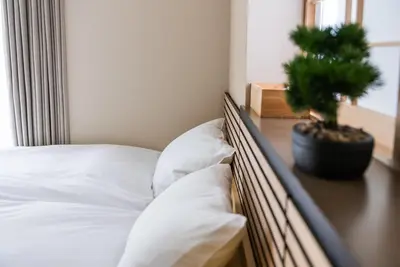 a bedroom with a bed with a potted plant on a table at Shinjuku 90sqm Private Villa with Sakura View Spacious & Quiet in Tokyo