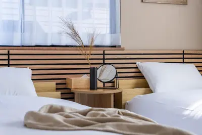 a bedroom with two beds and a mirror on a table at Shinjuku 90sqm Private Villa with Sakura View Spacious & Quiet in Tokyo