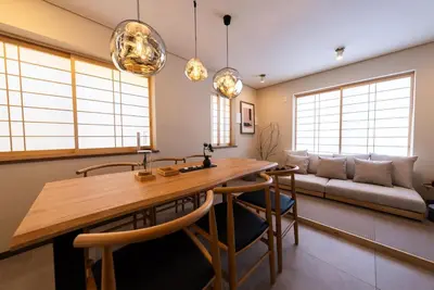a living room with a wooden table and a couch at Shinjuku 90sqm Private Villa with Sakura View Spacious & Quiet in Tokyo