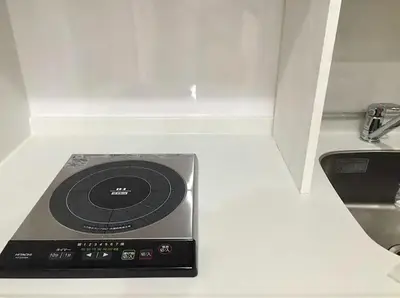 a stove in a kitchen with a sink at Space Air Building 5F - Vacation STAY 11430 in Tokyo
