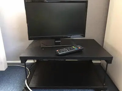 a computer monitor and a remote control sitting on a table at Space Air Building 5F - Vacation STAY 11432 in Tokyo