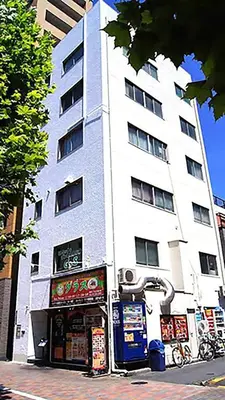 a tall white building with a store in front of it at Space Air Building 5F - Vacation STAY 11432 in Tokyo