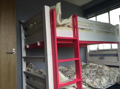 a red bunk bed in a room with two beds at Space Air Building 5F - Vacation STAY 11432 in Tokyo