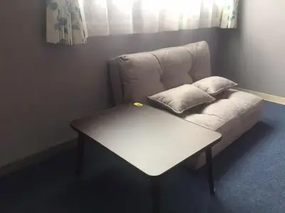 a white couch with a table in a room at Space Air Building 5F - Vacation STAY 11432 in Tokyo
