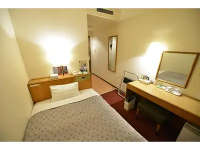 a bedroom with a bed and a desk and a mirror at Smile Hotel Tokyo Shinkoiwa - Vacation STAY 33620v in Tokyo