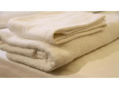 a pile of white towels sitting on top of a counter at Smile Hotel Tokyo Shinkoiwa - Vacation STAY 33626v in Tokyo
