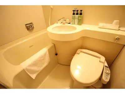 a small bathroom with a toilet and a sink at Smile Hotel Tokyo Shinkoiwa - Vacation STAY 33631v in Tokyo