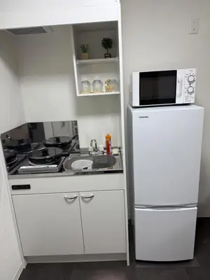 a white kitchen with a microwave and a refrigerator at Taito-ku - House - Vacation STAY 20130 in Tokyo