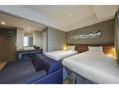 a hotel room with two beds and a couch at Far East Village Hotel Tokyo Ariake - Vacation STAY 31697v in Tokyo