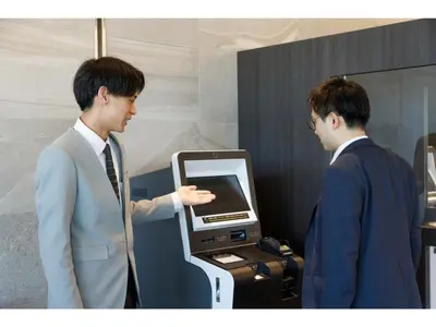 two men in suits standing next to a cash register at Far East Village Hotel Tokyo Ariake - Vacation STAY 31673v in Tokyo