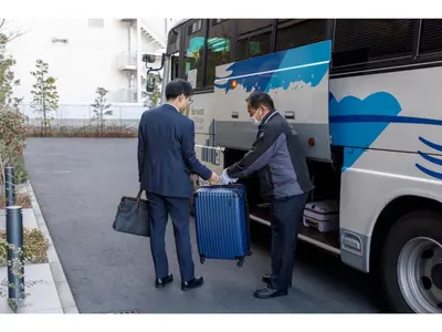 two people shaking hands in front of a bus at Far East Village Hotel Tokyo Ariake - Vacation STAY 31631v in Tokyo