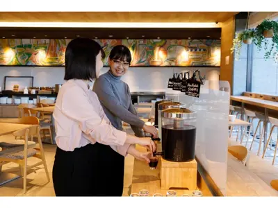 a man and woman standing behind a counter with a blender at Far East Village Hotel Tokyo Ariake - Vacation STAY 31643v in Tokyo