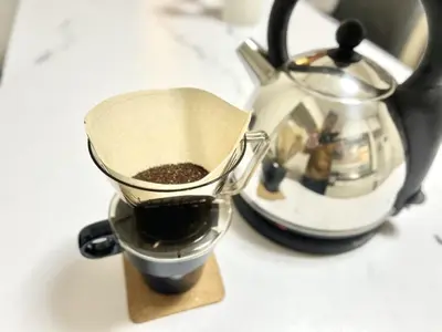 a measuring cup with coffee in it next to a tea kettle at Katsushika-ku - House - Vacation STAY 20111 in Tokyo