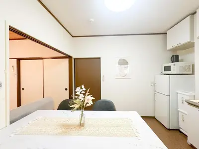 a kitchen with a table with a vase of flowers on it at Katsushika-ku - House - Vacation STAY 20111 in Tokyo