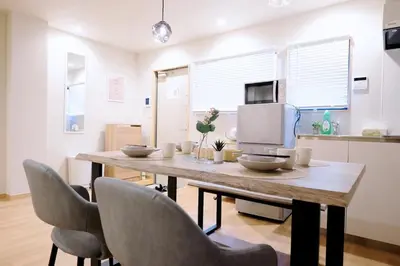 a dining room table with chairs and a television at Belshaart Kamikitazawa - Vacation STAY 20141 in Tokyo
