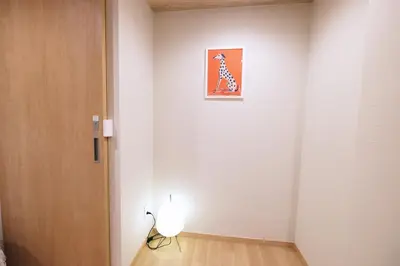 a room with a white wall with a dog picture on the wall at Belshaart Kamikitazawa - Vacation STAY 20141 in Tokyo