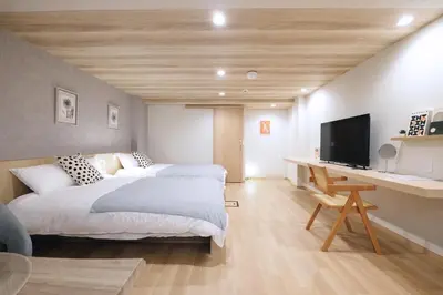 a bedroom with a bed and a desk with a tv at Belshaart Kamikitazawa - Vacation STAY 20141 in Tokyo