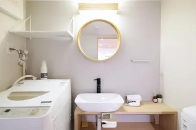 a bathroom with a white sink and a mirror at Belshaart Kamikitazawa - Vacation STAY 20141 in Tokyo
