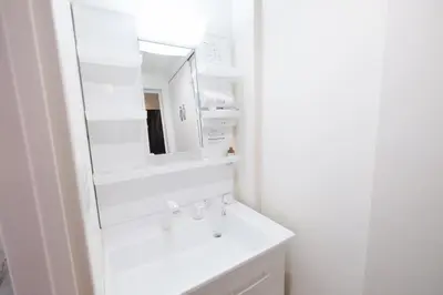 a white bathroom with a sink and a mirror at Belshaart Kamikitazawa - Vacation STAY 20138 in Tokyo