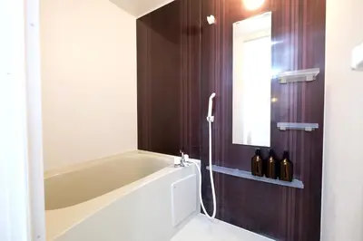a bathroom with a bath tub and a window at Belshaart Kamikitazawa - Vacation STAY 20138 in Tokyo