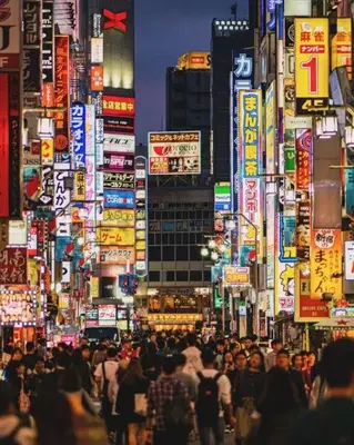 a crowd of people walking down a busy city street at Okubo Gury Sanny in Tokyo