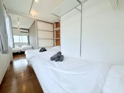 a bedroom with three beds with shoes on them at Terrace Tokyo Sugamo in Tokyo
