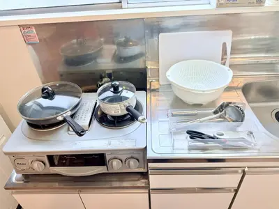 a stove with pots and pans on top of it at Terrace Tokyo Sugamo in Tokyo