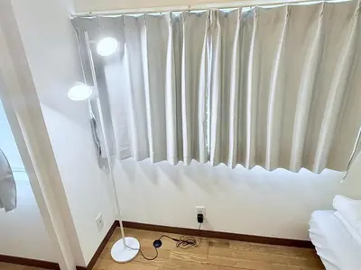 a bedroom with a window with white curtains at Terrace Tokyo Sugamo in Tokyo