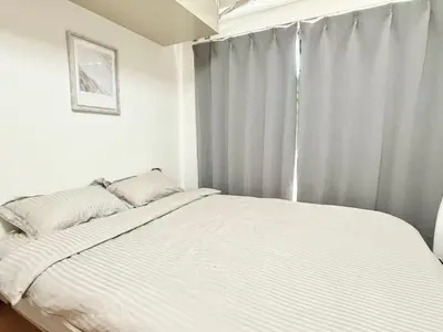 a white bed in a bedroom with a window at Ikebukuro Sugamo\u99c5\u8fd1B4 in Tokyo