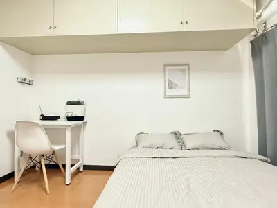 a white bedroom with a bed and a desk at Ikebukuro Sugamo\u99c5\u8fd1B4 in Tokyo
