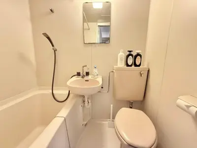 a white bathroom with a toilet and a sink at Ikebukuro Sugamo\u99c5\u8fd1B4 in Tokyo